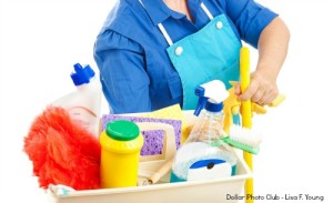 Maid holding cleaning supplies. White background.