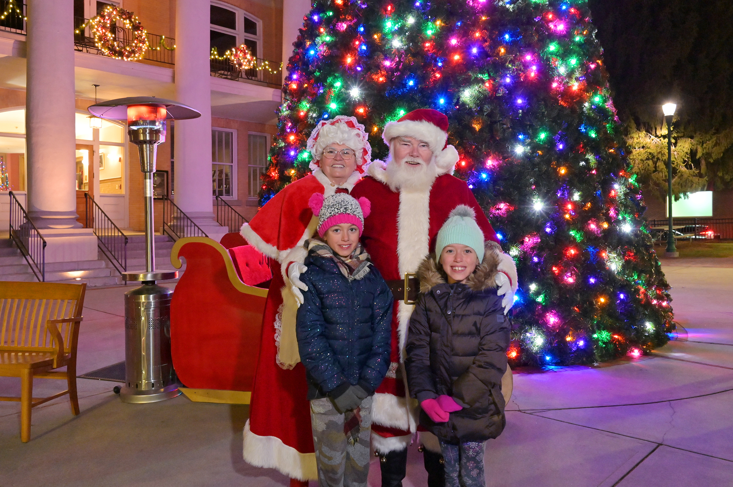 Santa Claus and kids spreading cheer in downtown Hendersonville during holiday events.