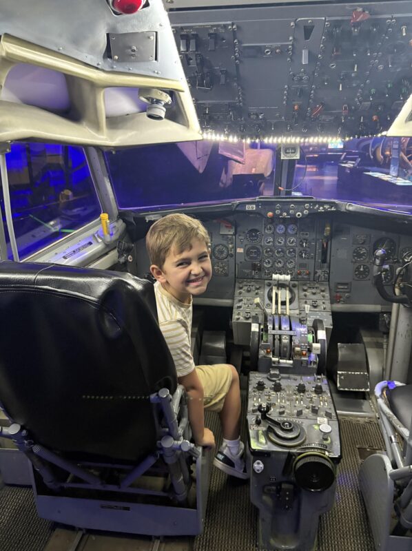 boy in cockpit of plane at Sullenberger Aviation Museum