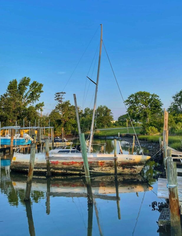 Abandoned sailboat at dock in Morehead City, North Carolina