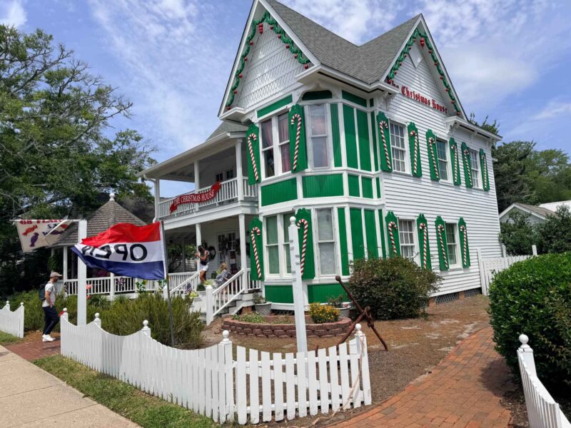 The Christmas House outside green & white house