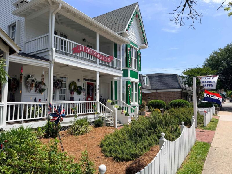 The Christmas House outside green & white house
